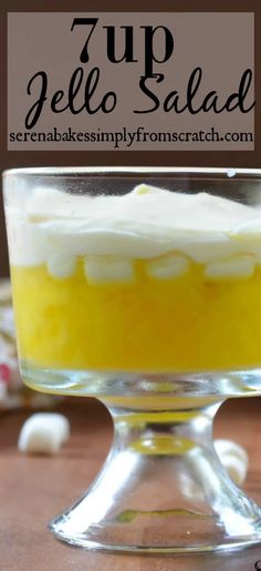 a cake in a glass dish with white frosting on top and the words 7 up jello salad above it