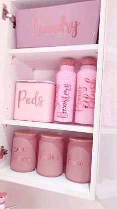 some pink jars are sitting on a shelf