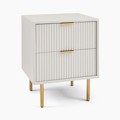 a white cabinet with two gold handles on the bottom and one drawer in the middle