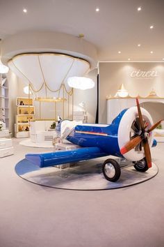 a blue and white airplane on display in a store