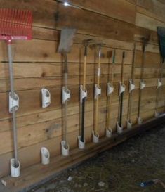 there are many different types of tools on the wall in this room with wood paneling