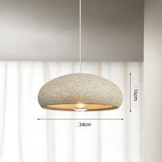 a light fixture hanging from the ceiling with measurements for it's length and height