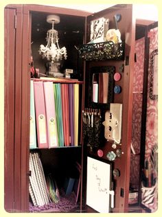 an open book case filled with lots of books and binders on top of a purple carpet