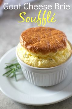 a close up of a plate of food on a table with the words goat cheese brie souffle