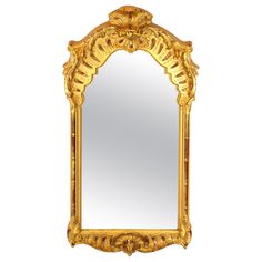 an ornate gold framed mirror against a white background