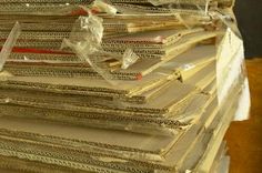 stacks of old books are wrapped in plastic and ready to be used as wall hangings