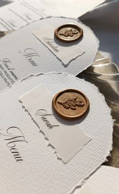 two envelopes with wax stamp on them and one has a coin in the middle