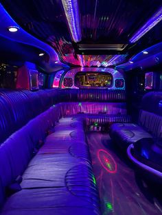 the inside of a limo with purple and blue lights on it's walls,