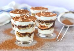 three desserts sitting on top of a table covered in frosting and toppings