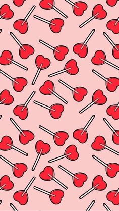 a pink background with hearts and lollipops on sticks in the shape of hearts