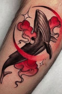 a tattoo with a whale on it's leg