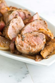 some meat and potatoes on a white plate