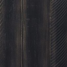 an image of black wood textured with lines and curves on the grained surface