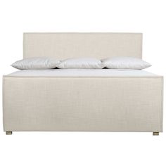 a bed with white linen and pillows on it's headboard, against a white background