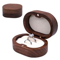 an open wooden box with a wedding ring inside