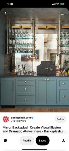 a kitchen with blue cabinets and gold trim around the counter top, along with glassware