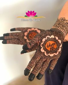 a woman's hands with henna tattoos on it