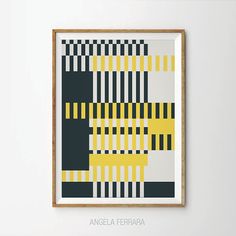 a framed art print with yellow and black squares on it's wall above a chair