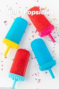 three ice cream popsicles with sprinkles on them