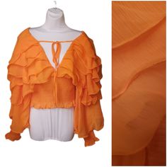 This Is A Ruffle Top With Tons Of Personality. The Material Is Sheer, But Added To The Elastic Base At The Torso And Cuffs Makes Those Areas Opaque. There Are Layers Of Sheer Ruffles Across The Shoulders And Arms. There Is A Very Deep Vneck That Is Secured With A Tie At The Chest. Great As A Summer Top Or As A Decorative Topper To A Dress. I Make Deals On All Bundles! Due To Nuances In Lighting, Camera Capabilities, And Viewing Screens, Colors May Be Different Than They Appear. Please Check Meas Spring V-neck Peasant Top With Ruffles, Fitted Summer Blouse With Ruffle Sleeves, V-neck Ruffle Blouse For Night Out, Fitted Blouse With Ruffle Sleeves For Summer, Fitted Peasant Top With Ruffles For Fall, Trendy Spring Blouse With Ruffles, Trendy Summer Blouse With Ruffled Collar, Trendy Party Blouse With Ruffle Hem, Spring Night Out Blouse With Ruffle Hem