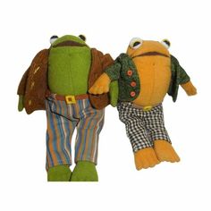 two stuffed animals that look like they are wearing clothes and holding hands with each other