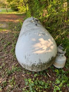 an old tank is sitting in the grass