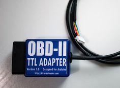 an obd - ii adapter attached to a computer cable with the words'obd - ii'on it