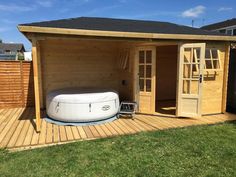 a hot tub sitting on top of a wooden deck