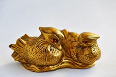 two gold birds sitting on top of each other