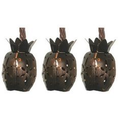 three metal pumpkins with lights on them