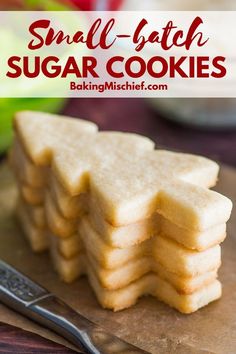 small batch sugar cookies stacked on top of each other next to a bowl of fruit