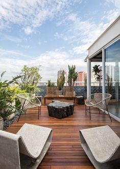 a wooden deck with chairs and tables on it