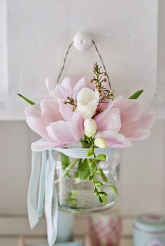 a vase filled with pink and white flowers