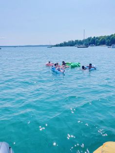 several people are floating on surfboards in the water