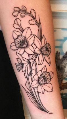 a black and white flower tattoo on the arm