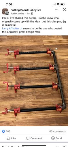 three red and black pipes are connected to each other on a wooden floor with an instagram