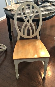 a wooden chair sitting on top of a hard wood floor next to a dining room table