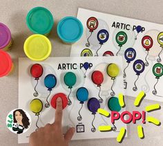 someone is pointing at some sort of pop artic pop activity for kids to practice their fine motor skills