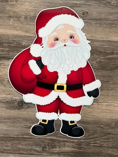 a santa clause sticker sitting on top of a wooden table