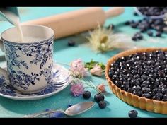 a blueberry tart is being poured into a cup