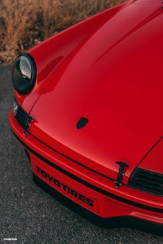 the front end of a red sports car