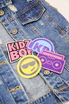 some stickers that are on the back of a jean jacket, and one has an image of a boombox