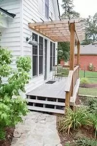 an outside view of a house with steps leading up to the front door and covered porch