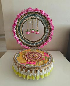 a decorative box with flowers on it sitting on a table