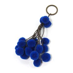 a bunch of blue pom - poms hanging from a key chain