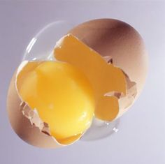 an egg is broken in half on a plate