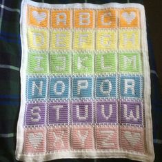 a crocheted blanket with letters on it