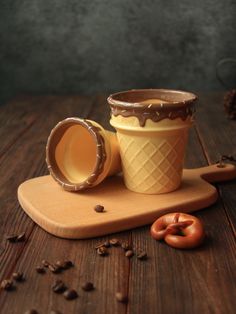 an ice cream sundae with chocolate icing and pretzels on a cutting board