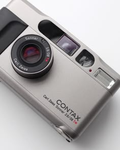 a silver camera sitting on top of a white table