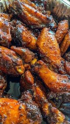 chicken wings covered in bbq sauce on a tray